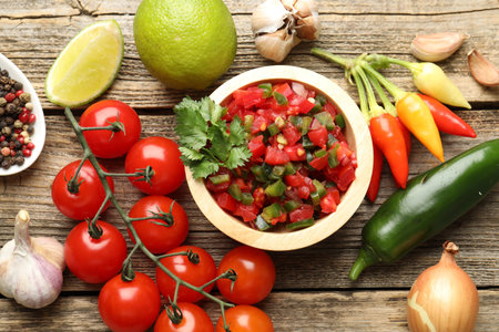Tasty salsa and ingredients on wooden table, flat layの写真素材