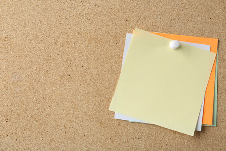 Blank colorful notes pinned on cork board, space for textの写真素材