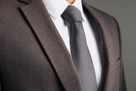 Man in suit with stylish necktie on gray background, closeupの写真素材