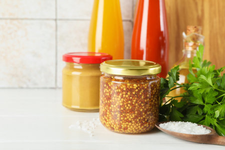 Different tasty sauces, parsley and salt on white wooden table, closeup. Space for textの写真素材