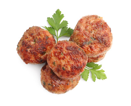 Delicious meat patties with parsley isolated on white, top viewの写真素材