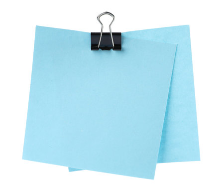 Blank paper notes attached with blinder clip isolated on whiteの写真素材