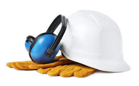 Safety equipment. Hard hat, earmuffs and protective gloves isolated on whiteの写真素材