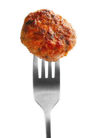 Fork with roasted meat patty isolated on whiteの写真素材
