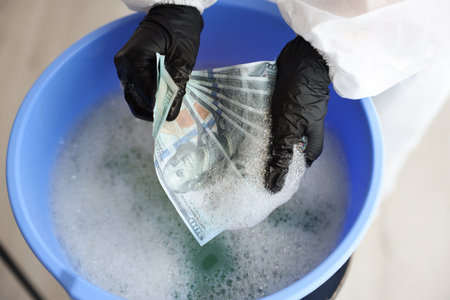 Money laundering. Woman washing dollar banknotes in basin indoors, above viewの写真素材