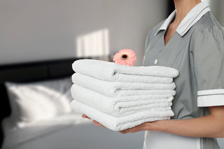 Woman with clean towels in hotel room, closeupの写真素材