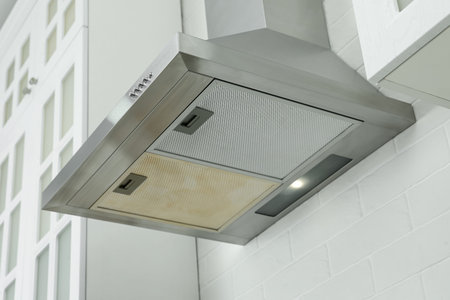 Range hood with mesh filters in kitchen. Before and after cleaning, collage