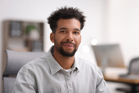 Portrait of handsome man in shirt at workplaceの写真素材