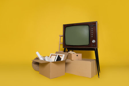 Garage sale. Different used stuff on yellow background, space for textの写真素材