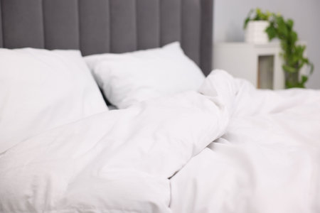 Bed with cozy fresh lines indoors, closeupの写真素材
