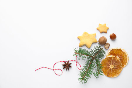 Christmas composition with fir tree branches, cookies and spices on white background, flat lay. Space for textの写真素材