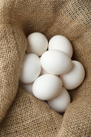 Many raw eggs in sack, closeup