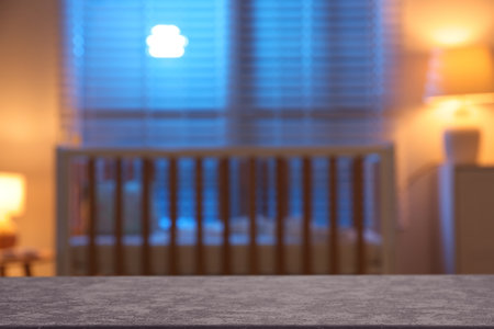 Empty table against crib in baby room. Space for designの写真素材