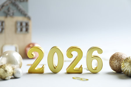 New 2026 Year. Golden numbers, confetti and shiny baubles on light background, closeupの写真素材