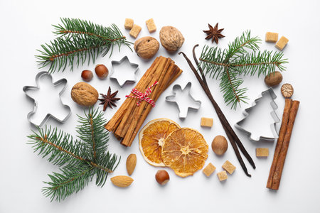Christmas composition with fir tree branches, cookie cutters and spices on white background, flat layの写真素材