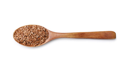 Flax seeds in spoon isolated on white, top viewの写真素材