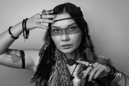 Shaman woman with face painting on light background, black and white effect