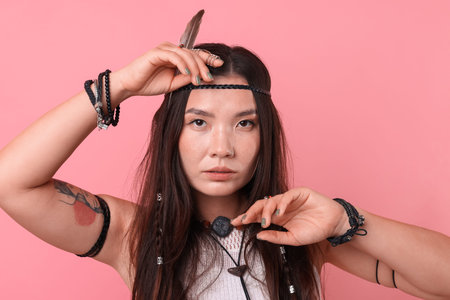 Shaman woman in feather headdress on pink background