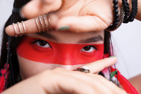Shaman woman with face painting on light gray background, closeupの写真素材