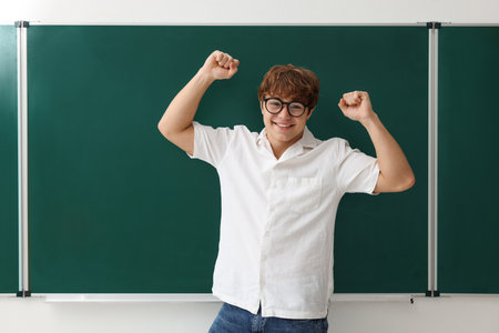 Back to school. Happy boy near chalkboard indoorsの写真素材