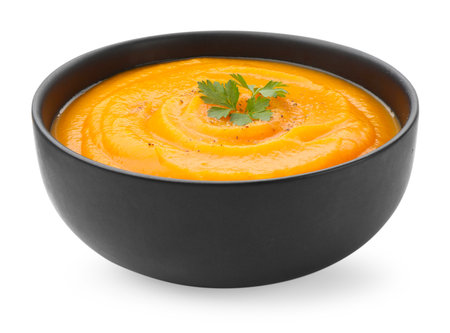 Tasty pumpkin cream soup with spices in bowl isolated on whiteの写真素材