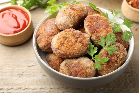 Tasty meat patties served on wooden table, closeup
