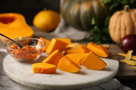 Fresh squash, seeds, peels and spices on wooden table, closeupの写真素材