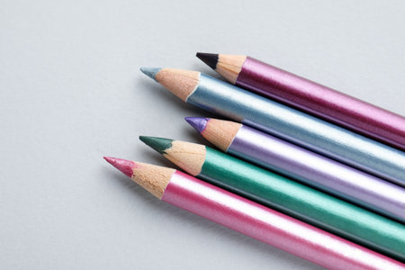 Colorful eye pencils on light background, flat layの写真素材