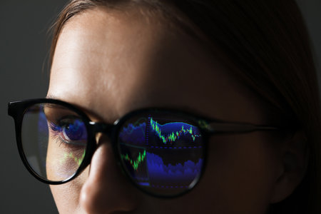 Young woman wearing glasses with reflection on gray background, closeupの写真素材