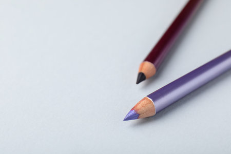 Two eye pencils on light background, closeup. Space for textの写真素材