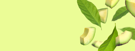 Fresh avocado slices and leaves falling on light green background