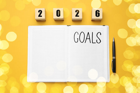 New Year. 2026 made of cubes and notebook with word Goals on orange background, top viewの写真素材
