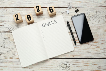 New Year. 2026 made of cubes and notebook with word Goals on wooden table, top viewの写真素材