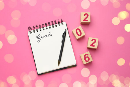 New Year. 2026 made of cubes and notebook with word Goals on pink background, top viewの写真素材