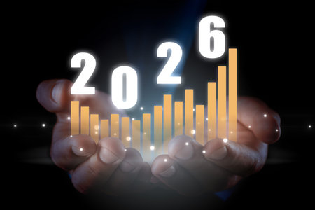New 2026 Year. Businessman holding virtual numbers and graph in hands against black background,...