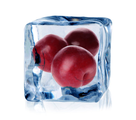 Plums inside ice cube isolated on whiteの写真素材