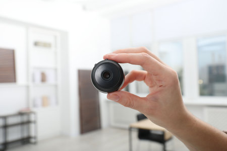 Woman with hidden spy camera on blurred background, closeupの写真素材