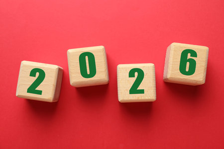 New 2026 Year. Wooden cubes with numbers on red background, top view