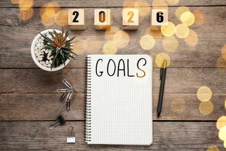 New Year. 2026 made of cubes and notebook with word Goals on wooden table, top viewの写真素材