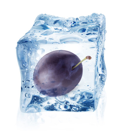Fresh plum inside ice cube isolated on whiteの写真素材