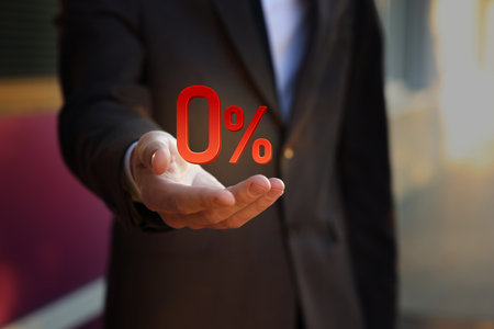 Businessman holding 0 percent sign in hand, closeup. Zero commissionの写真素材