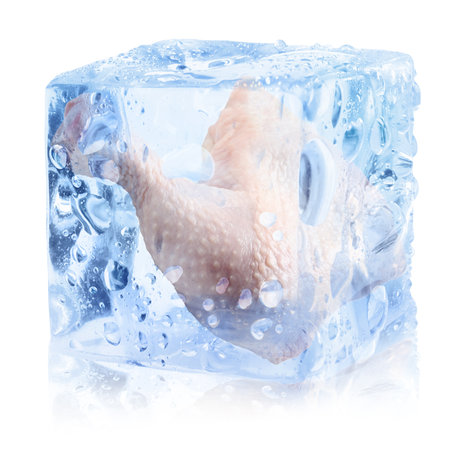 Raw chicken leg quarter in ice cube on white background.の写真素材
