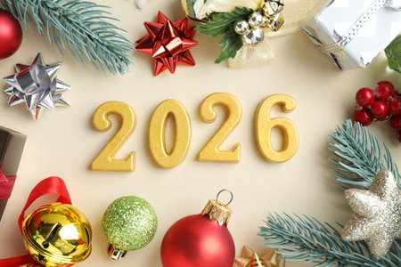 New 2026 Year. Golden numbers and festive decor on beige background, flat layの写真素材
