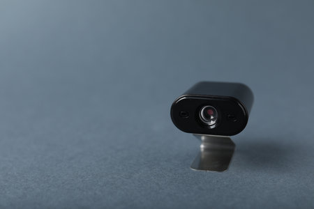 Hidden spy camera on gray background, closeup. Space for textの写真素材