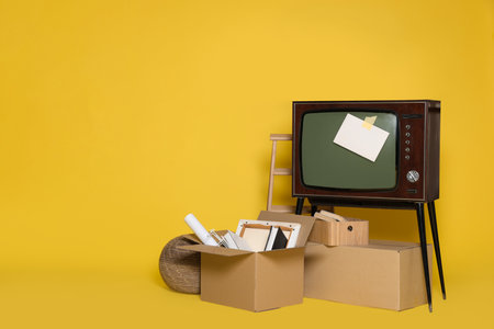 Garage sale. Different used stuff on yellow background, space for textの写真素材