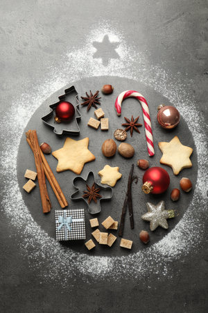 Bauble shape made with flour, Christmas decor, cookies and spices on gray table, flat layの写真素材