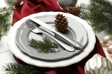 Festive table setting with Christmas decor on white wooden background, closeupの写真素材