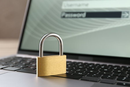 Password concept. Closed padlock and laptop on table, closeupの写真素材