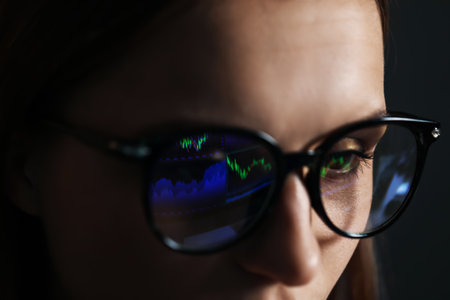 Young woman wearing glasses with reflection on dark background, closeupの写真素材