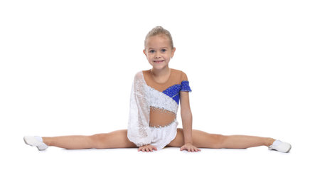 Smiling little girl doing gymnastic exercise on white backgroundの写真素材